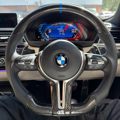 BMW carbon fibre steering wheel viewed from the driver's seat