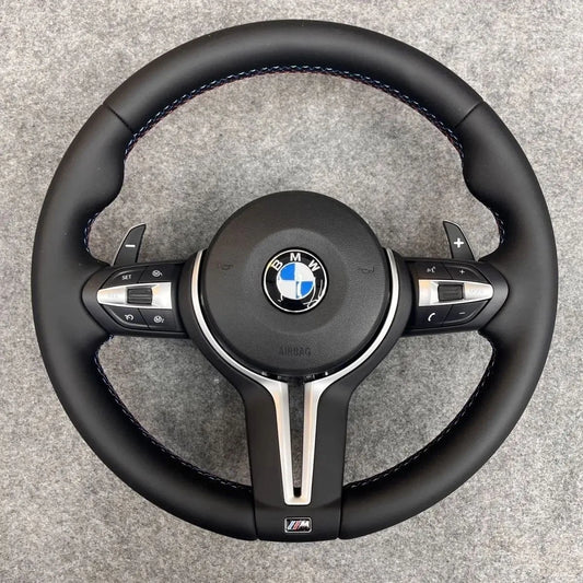 BMW M Sport steering wheel, front view showing leather rim and M Sport badge
